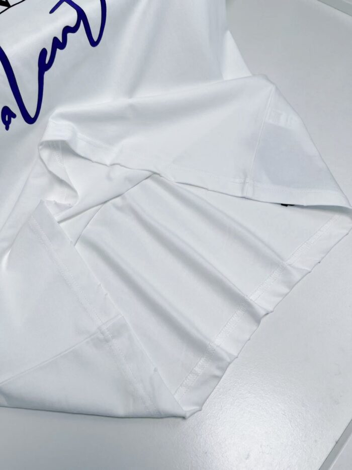 Camicia bianca elegante con logo blu cursivo, dettagli raffinati e tessuto di alta qualità.