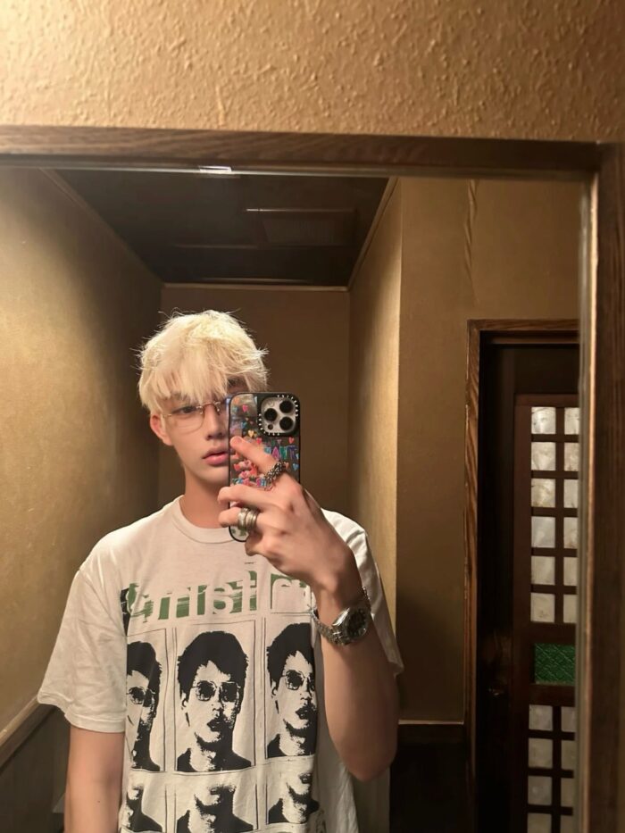 Ragazzo giovane in selfie nel corridoio di casa, stile casual e atmosfera intima